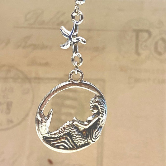 Reclining mermaid with starfish earrings