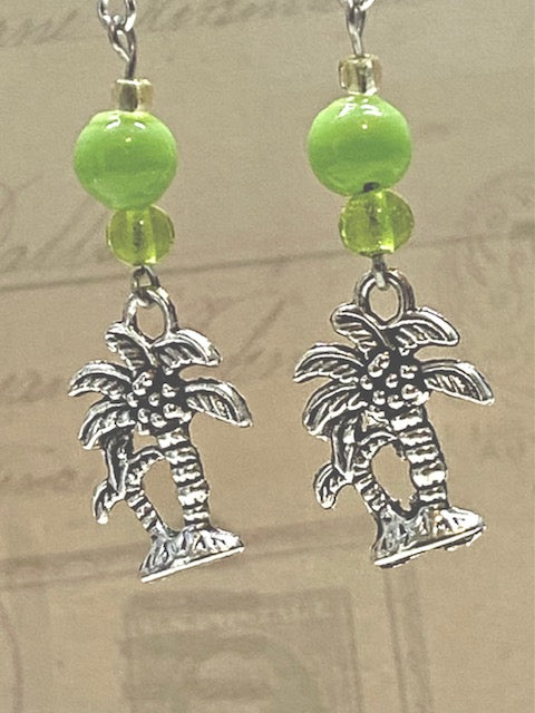 Silver palm tree earrings with bright green glass bead accents