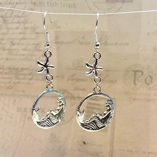 Reclining mermaid with starfish earrings