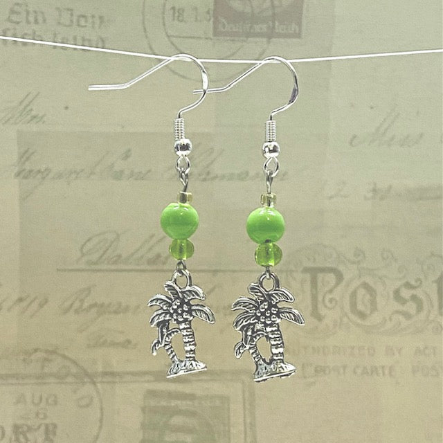 Silver palm tree earrings with bright green glass bead accents