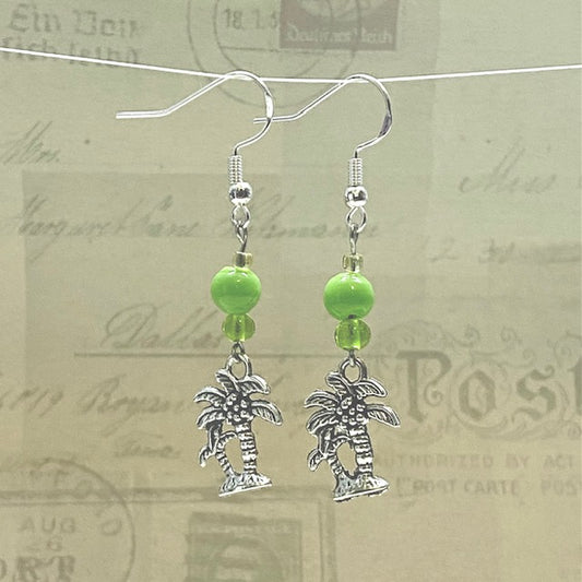 Silver palm tree earrings with bright green glass bead accents