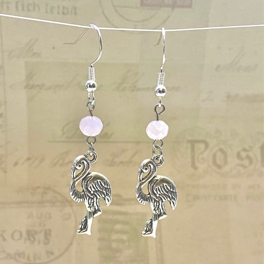 Silver flamingo earrings with light pink glass beads.